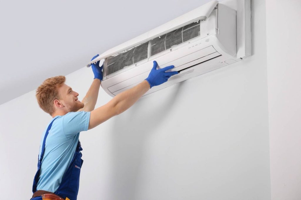 cosmic comfort technician repairing ac